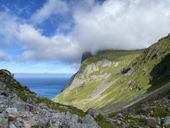 Scenic view of sea and mountains against sky