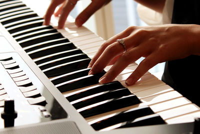 Midsection of woman playing piano