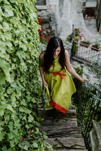 High angle view of woman walking on steps against trees