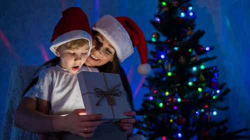 Boy holding christmas tree