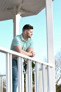 Low angle view of young man looking at camera