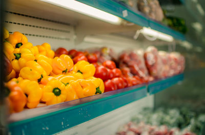 Yellow bell peppers on shelf for sale at store