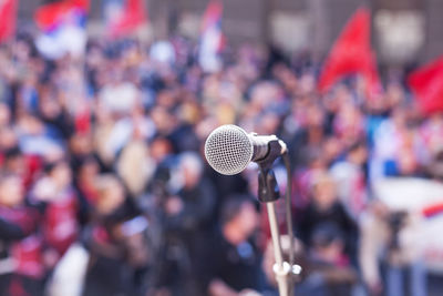 Close-up of microphone against crowd