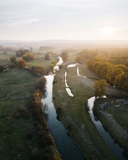 High angle view of river amidst landscape against sky