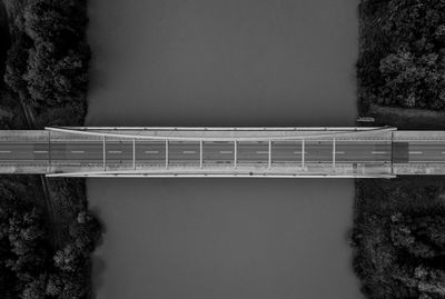 Bridge over river against clear sky during winter