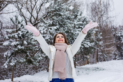 Woman with arms outstretched in snow