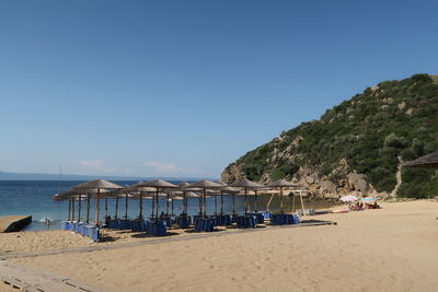 Scenic view of beach against clear blue sky