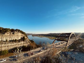 High angle view of bridge over road against blue sky