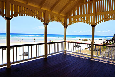 View of beach from gazebo against blue sky