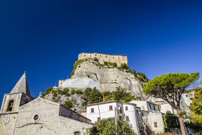 Low angle view of building against blue sky