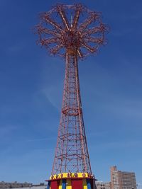 Low angle view of ferris wheel against blue sky