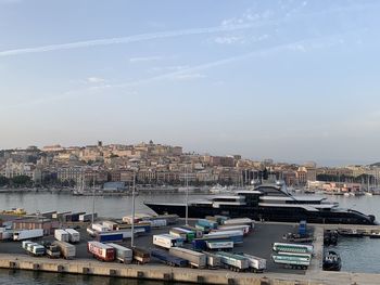 High angle view of harbor by buildings against sky