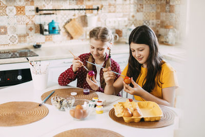 Young woman having food at table