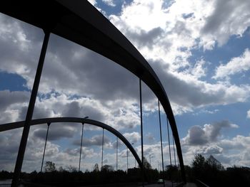 Low angle view of silhouette bridge against sky