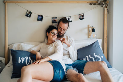 Couple kissing while sitting at home in bed