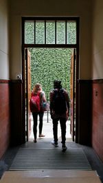 Rear view of women walking in corridor