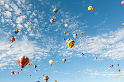 Low angle view of balloons flying against sky