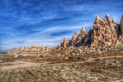 Rock formations on landscape against sky