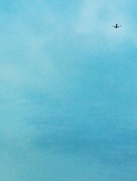 Low angle view of airplane flying in sky