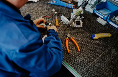 Midsection of man working on table