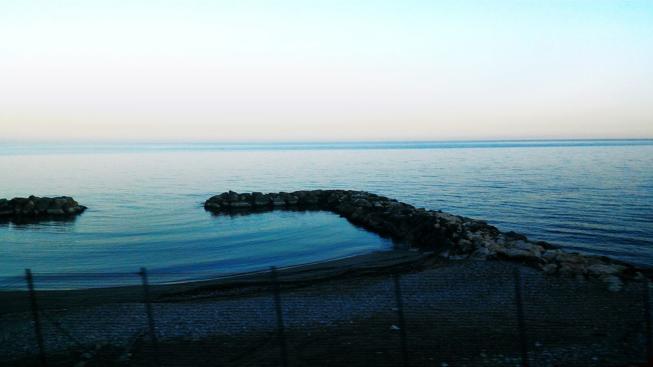 sea, horizon over water, water, tranquil scene, tranquility, scenics, beauty in nature, clear sky, copy space, beach, nature, shore, idyllic, sky, remote, calm, blue, non-urban scene, outdoors, seascape