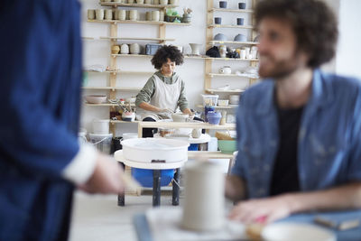 Woman molding clay in pottery class