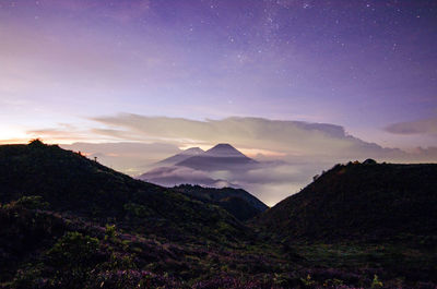 Scenic view of mountains against sky at night