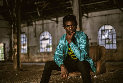 Portrait of young man sitting outdoors