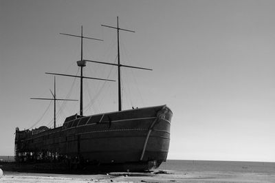 Beached and damaged sailing ship run aground
