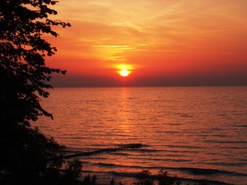 Scenic view of sea against orange sky