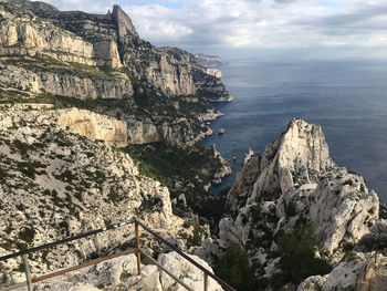 Scenic view of sea and mountains against sky
