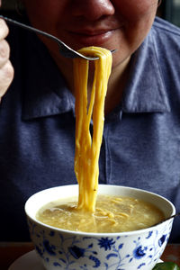 Close-up of person holding drink in bowl