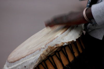 Close-up of hand on wood