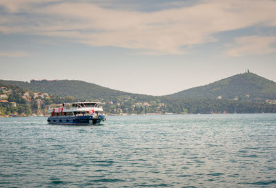 Boat sailing on sea against sky