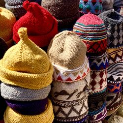 Close-up of multi colored knit hats for sale at market stall