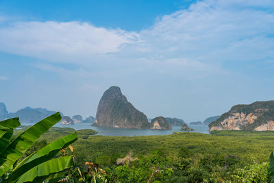 Scenic view of sea and mountains against sky