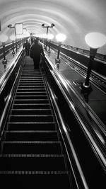 Low angle view of people on escalator at subway station