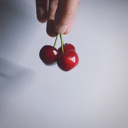 Close-up of hand holding strawberry