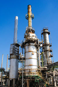 Low angle view of smoke stack against sky