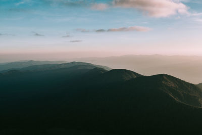 Scenic view of mountains against cloudy sky