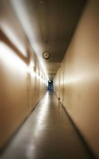 Empty illuminated corridor in building