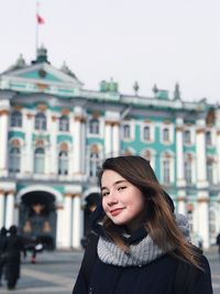 Portrait of woman standing in city during winter