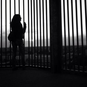 Full length of woman standing in the dark