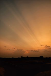 Scenic view of silhouette field against romantic sky at sunset