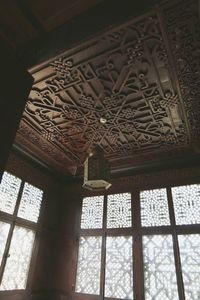 Low angle view of ornate window in temple