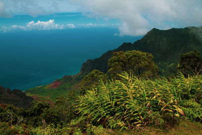 Scenic view of sea and mountains against sky