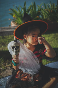 Portrait of boy holding hat during halloween