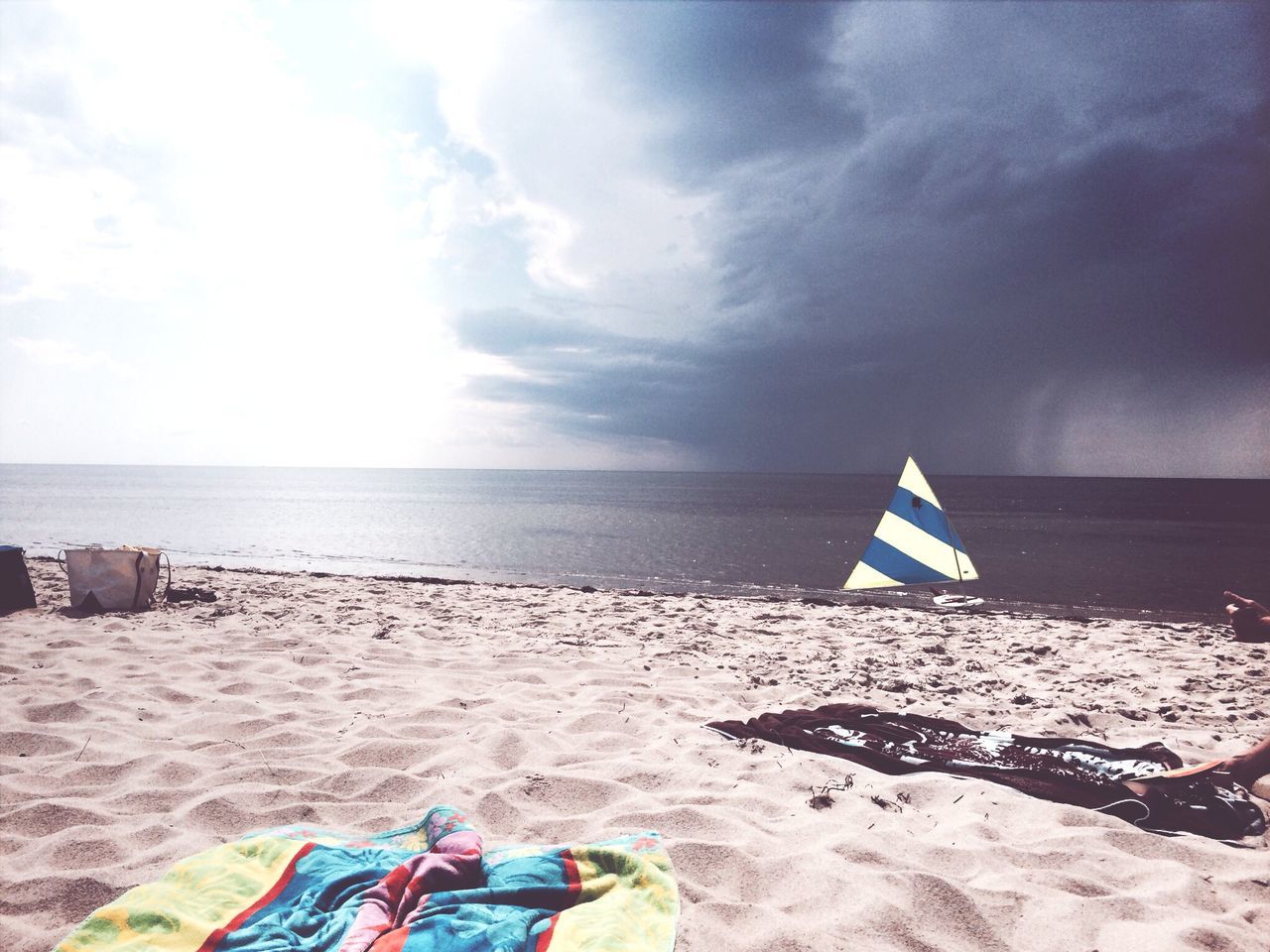 beach, sea, horizon over water, sand, sky, shore, water, cloud - sky, beach umbrella, tranquility, tranquil scene, scenics, vacations, nature, parasol, beauty in nature, flag, cloud, protection, sunshade