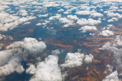 Altocumulus clouds view from above . flight panorama of white clouds and earth