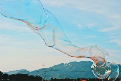 Low angle view of bubbles against sky